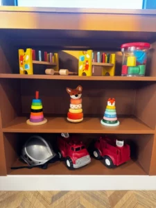 Bibliothèque avec de nombreux jouets dans la micro crèche